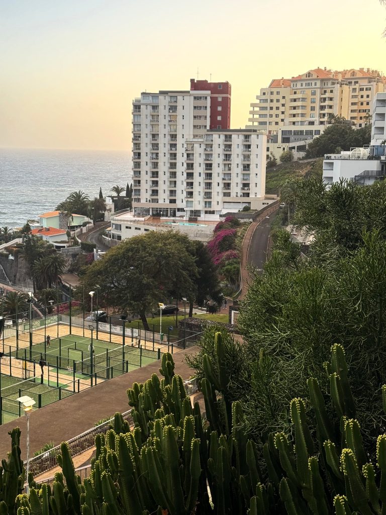 Tall hotels of the Lido district, tennis courts and the ocean at sunset, seen from outside the Alto Lido hotel
