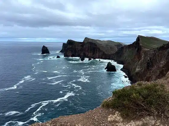 Die Klippen der Ponta de São Lourenço fallen in eine Bucht ab, Felsnadeln im schäumenden Ozean